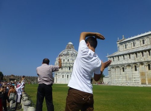 People holding up the leaning tower of Pisa